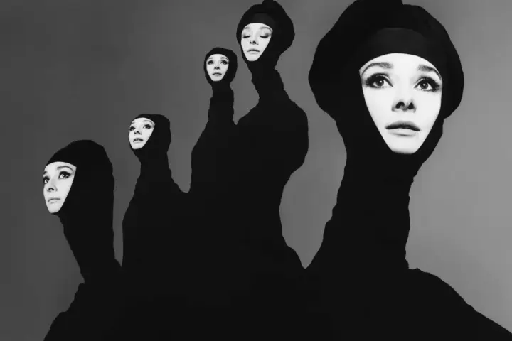 Pięć twarzy Audrey Hepburn w czarnych kapturach, jakby wyłaniających się z mroku. Ikoniczne ujęcie w stylu Richarda Avedona.